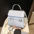 Elegante hellblaue kleine quadratische Tasche aus Lackleder mit Schleife und Griff - Blau
