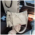 Elegant white pleated shoulder bag with bow knot and silver chain in car interior - Off White