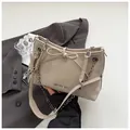 Elegant cream shoulder bag featuring a decorative bow and stylish metal chain strap - Khaki