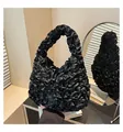 Detailed close-up of a black pleated handbag with layered ruffle texture and satin finish - One Size / Black