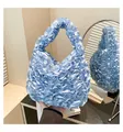 Close-up of light blue pleated satin handbag with ruffled texture and soft silk sheen - One Size / Blue