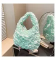 Detailed view of mint green pleated ruffle handbag with silky glossy fabric finish - One Size / Green