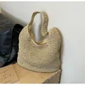 Detailed close-up of handmade woven straw tote bag with textured crochet and inner lining - One Size / Off White