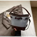 Light blue canvas and brown leather bucket bag with toggle closure and shoulder strap - One Size / Blue