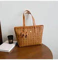Brown vintage tote bag with bear print and cute dog charm on a wooden table - With Pendant / Brown