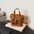 Brown leather crossbody bag with cartoon bear prints and dog charm on white book base - Single Bag / Brown