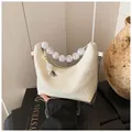 Detail of cream faux crocodile texture bag with large pearl beads and chain strap - White Crocodile Pattern
