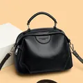 Elegant black lychee grain leather shell bag with top handle and silver hardware detail - Black