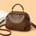 Fashionable dark brown pebble leather handbag with curved handle and crossbody strap - Coffee