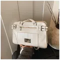 Cream white faux leather handbag featuring a glossy finish and vintage metal buckle detail - One Size / White