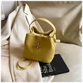 Bright yellow lychee grain bucket bag with metal turn-lock and crossbody strap - One Size / Yellow