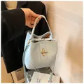 Light blue lychee textured bucket bag with golden twist lock and adjustable strap - One Size / Blue