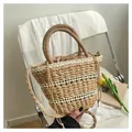 Close-up of woven straw bucket bag showing textured pattern and drawstring closure - Khaki