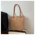 Detail der hohlen floralen Strickstruktur der beigen Strohtasche mit Lederriemen - Einheitsgröße / Khaki