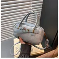 Detail of light blue woven texture handbag with leather straps and gold buckle accents - One Size / Blue