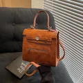 Caramel brown vintage small square bag with top handle and decorative metal buckle strap - Brown