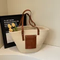 Beige woven straw tote bag with brown leather handles and decorative front pocket - One Size / Off-white