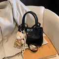 Minimalist black glossy crossbody bag with silver twist lock and plush bear pendant - With Charm / Black (with Pendant)