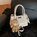 Chic beige tote bag in glossy PU leather with a teddy bear charm and silver twist lock - With Charm / Beige (With Charm)