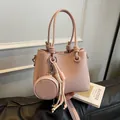 Elegant light pink pebbled leather bucket bag featuring a round coin purse pendant - No Pendant / Pink