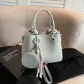 Chic light blue leather bucket bag featuring a knot handle and matching coin purse charm - No Pendant / Light Blue