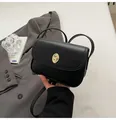 Minimalist black crossbody bag in matte leather finish with oval gold metal twist lock - Black