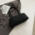 Black pebble leather bowling bag with white contrast stitching and dual handles - With Pendant / Black