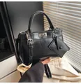 Macro detail of black leather bag with silver twist lock and mini triangle pouch - No Pendant / Black