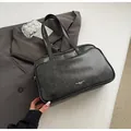 Minimalist black leather Boston bag with silver luxury logo and shoulder straps - No Pendant / Black