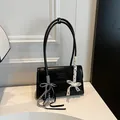 Chic black glossy leather shoulder bag with decorative bow and silver bead charms - With Pendant / Black