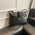 Classic black leather shoulder bag with gold horseshoe buckle and woven strap detail - Large / Black