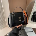 Minimalist black faux leather messenger bag with silver twist lock and orange rope charm - With Pendant / Black