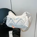White nylon shoulder bag with cute bow accents and adjustable strap for women - One Size / White