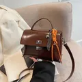Brown soft leather messenger bag with silver heart charm and orange woven knot detail - With Pendant / Coffee