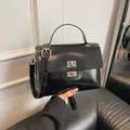 Chic black patent leather messenger bag with dual silver twist locks and top handle - No Pendant / Black