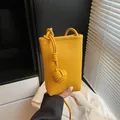 Vertical yellow litchi grain leather phone bag with elegant woven knot decoration - One Size / Ginger Yellow