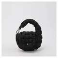 Detail shot of the quilted cloud handbag in black featuring a snap flap and metallic chain - One Size / Black