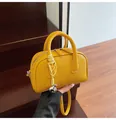 Bright yellow litchi grain leather crossbody bag with top handles and silver pendant - One Size / Ginger Yellow