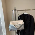 Minimalist silver metallic shoulder bag with a flip-top lock and sleek metal chain - S / Silver Small