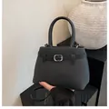 Elegant black textured leather crossbody handbag with silver buckle and top handle - Black