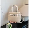Elegant beige and white woven handbag with matching leather straps and metal buckle - White