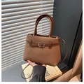 Chic brown woven handbag with leather handles and adjustable shoulder strap - Brown