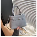 Chic light blue crossbody handbag with woven texture and silver square buckle detail - Blue