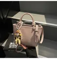 Pink lychee texture bucket bag with top handles, crossbody strap and cute charm - No Pendant / Purple