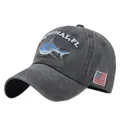 Close-up of shark embroidery and American flag patch on a washed grey cotton baseball cap - Adjustable / Black
