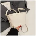 White litchi pattern leather bucket bag with silver heart charm and crossbody strap - One Size / White