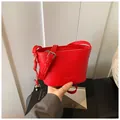 Vibrant red bucket bag in pebble leather with adjustable strap and heart charm - One Size / Red