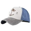 Close-up of distressed brim and anchor print on vintage color-block baseball cap - Coffee