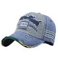 Detailed macro of vintage washed denim baseball cap with 1969 embroidery and distressed brim - Navy Blue and Grey