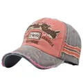 Detail of vintage 1969 Jamaica patch embroidery on washed pink and grey baseball cap - Coffee + Orange